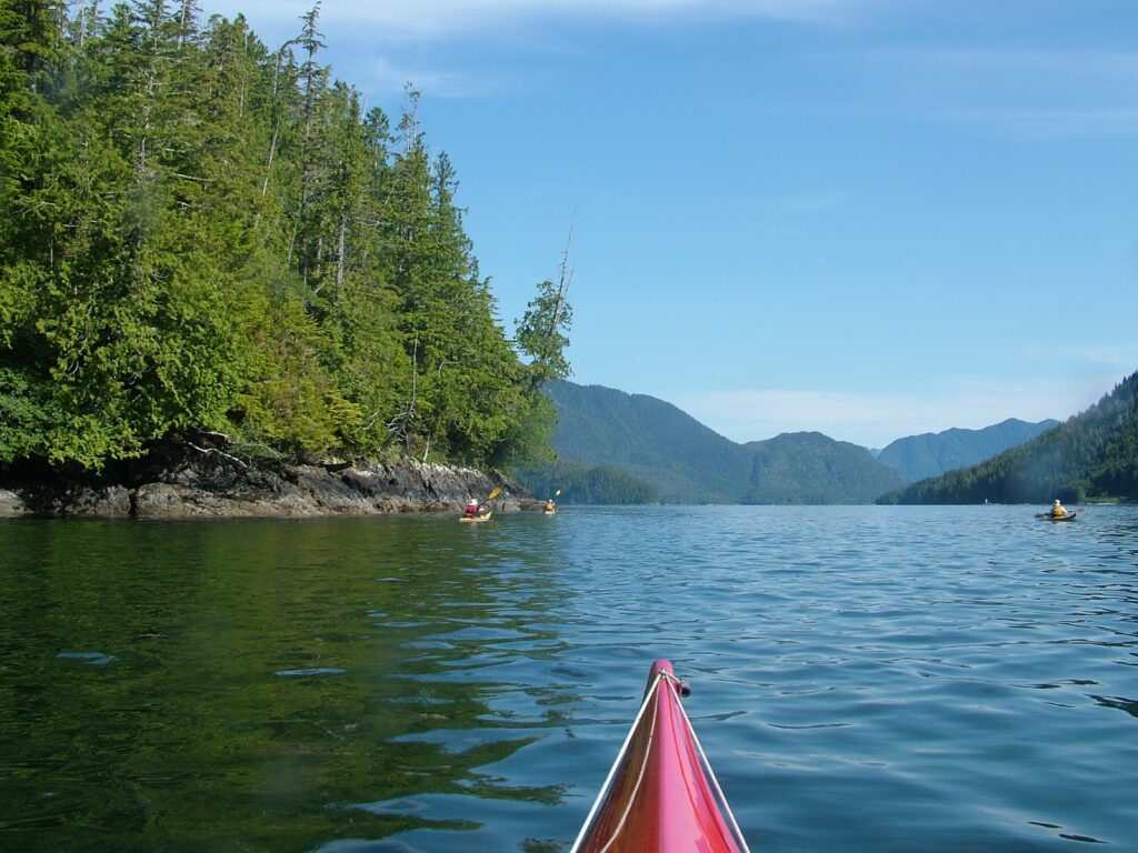image of shoreline and kayakers, vargas island, british columbia