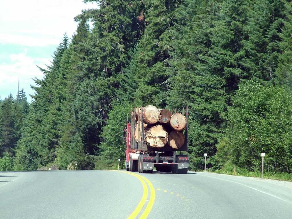 image of a logging truck on the highway, vancouver island, british columbia