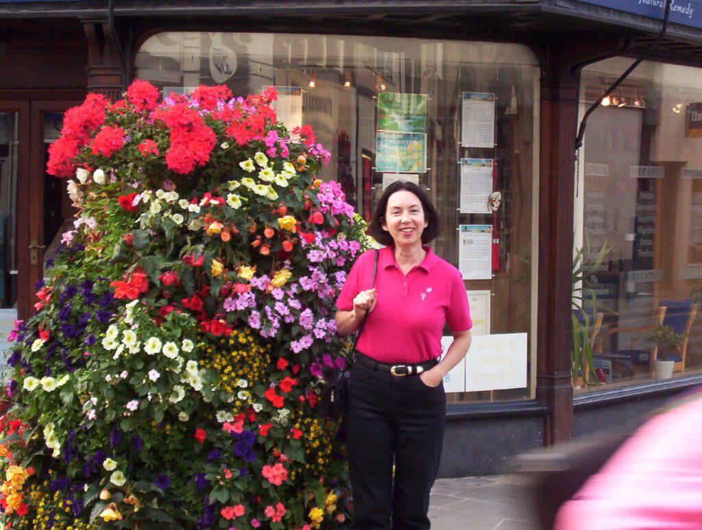 image of jean with a massive planter of flowers, England
