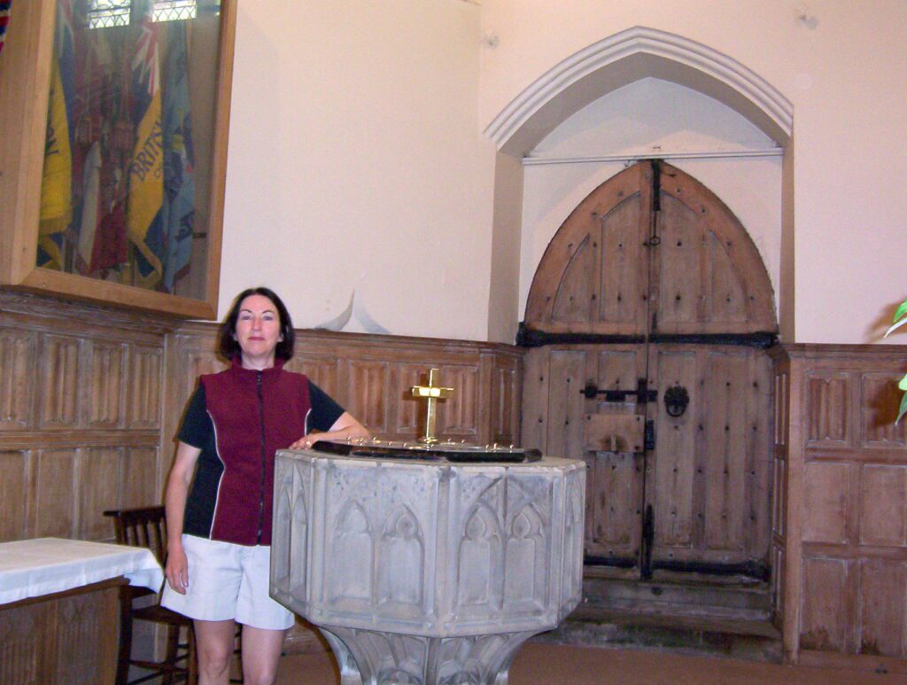 image of jean beside the font in St. Mary's Church, Barnsley, South Yorkshire, England