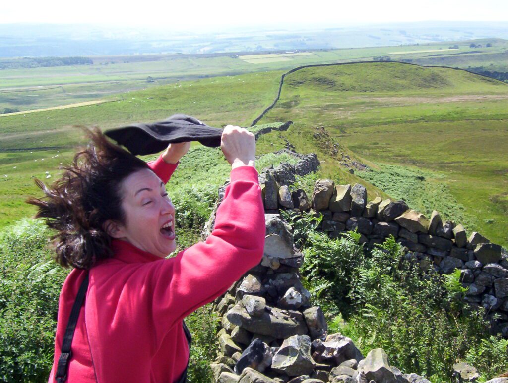 image of a wind-whipped person, Hotbank Crags, Hadrian's Wall, England
