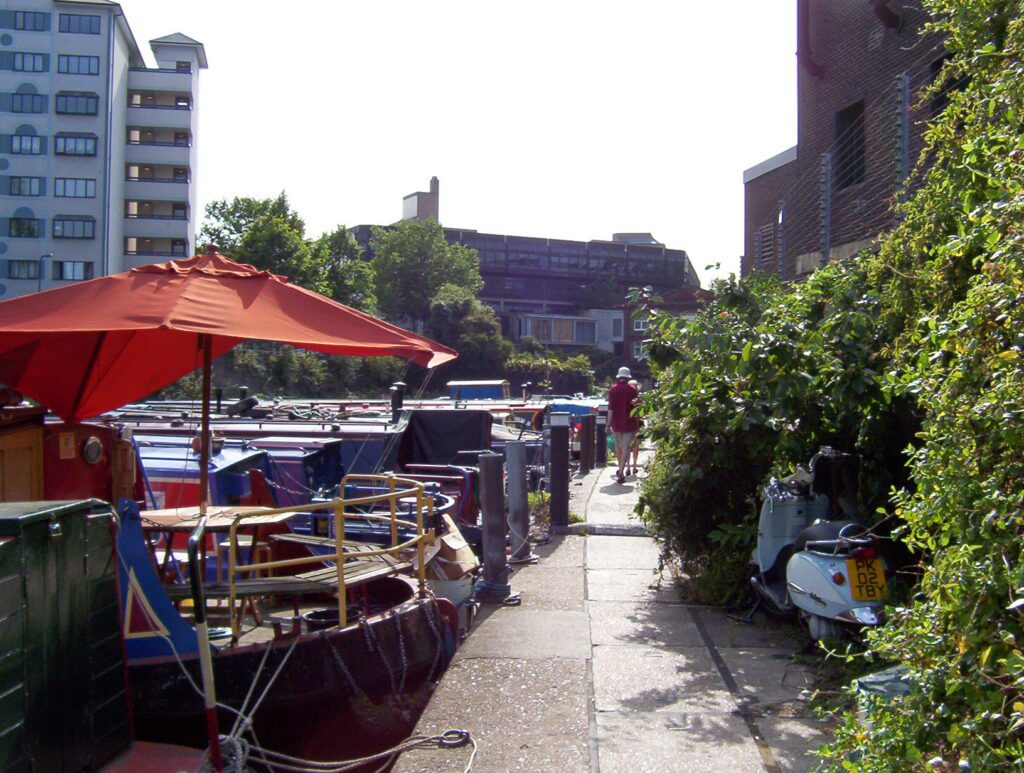 image of canal boats and barges moored along Regent's Canal, Camden Town, London, England