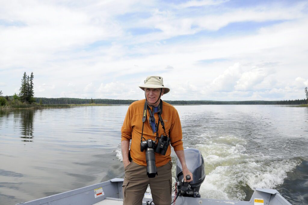 image of Bob helming a motorboat, Hanging Heart Lakes, Prince Albert National Park, Saskatchewan